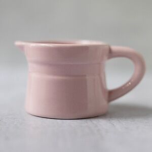 Pink ceramic unmarked creamer with debossed stripe 2 3/8 inches tall